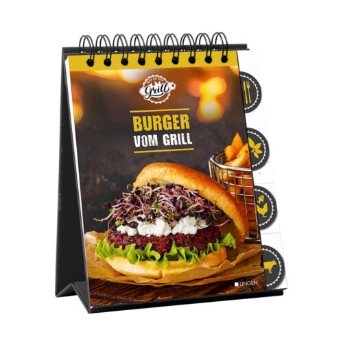 Spiralgebundenes Kochbuch mit der Abbildung eines mit Gemüse und Käse belegten Burgers und Pommes im Hintergrund.